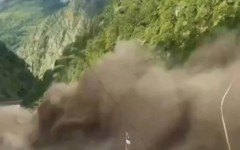 This frame grab from a UGC footage courtesy of Nepal Police shows floodwaters sweeping through houses along the Bhote Koshi River after flash floods in Rasuwa district on August 26, 2026.  Photo by-UGC / NEPAL POLICE / AFP