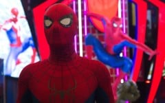 A man dressed as Spider-Man poses in front of a Marvel Studios Spider-Man booth. Ying Tang/NurPhoto via AFP