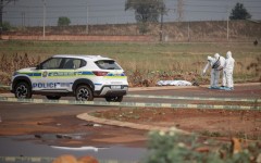 Members of the South African Police Service (SAPS) Forensic Pathology Services work on the crime scene where the body of a woman was discovered in Boksburg. AFP/Emmanuel Croset