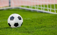 Closeup of a soccer ball and goalpost. GettyImages/artisteer