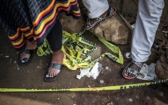 File: Residents stand behind police tape near a crime scene. AFP/Emmanuel Croset