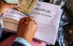 File: An IEC official assisting an elderly voter with a special vote. Gallo Images/Sharon Seretlo