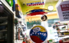 Venezuela-themed stickers decorate a window in the Doral food mart