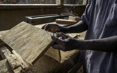 A man works as a carpenter in a workshop dedicated to training former child soldiers in the Democratic Republic of Congo