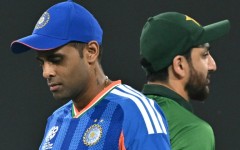 India's captain Suryakumar Yadav (L) walks past his Pakistan counterpart Salman Agha after the toss