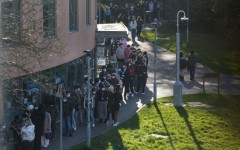 Students wearing face masks queue up for vaccines at the University of Kent in Canterbury, southeast England amid a deadly outbreak of meningitis