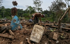 Farmer Jose Pena looks for belongings amid rubble after a bomb dropped by the Ecuadoran army in the Lago Agrio region of Ecuador on the border with Colombia