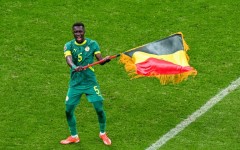 Idrissa Gueye waves the Senegal flag after his side beat Morocco on the field in the in the Africa Cup of Nations final in January