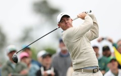 Defending champion and world number two Rory McIlroy of Northern Ireland plays a tee shot during a practice round for the 90th Masters at firm and fast Augusta National