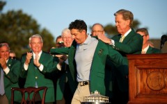 Rory McIlroy dons the green jacket after winning his second Masters in a row, forcing Augusta National chairman Fred Ridley to do the honor usually given to the prior year's champion