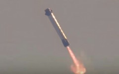 This screen grab taken from a Blue Origin broadcast shows the booster of Blue Origin's New Glenn rocket preparing to land on a floating platform in the Atlantic Ocean