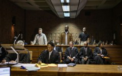 Kemi Seba (centre) was arrested alongside his son and a South African national