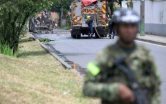 Colombian firefighters and soldiers deployed after a bomb explosion next to a military base in Cali
