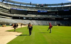 Pitch perfect: Workers install the pitch at New York New Jersey Stadium ahead of the 2026 FIFA World Cup