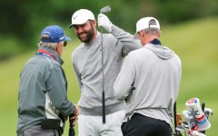 Top-ranked defending champion Scottie Scheffler, center, talks with caddie Ted Scott, right, and swing coach Randy Smith during a practice round at Aronimink ahead of the 108th PGA Championship