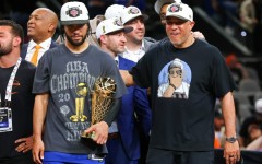 Jalen Brunson of the New York Knicks accepted the Bill Russell NBA Finals Most Valuable Player Award trophy with his father at his side