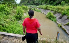 Eva Sevillano, a resident of the Nueva Prosperina neighborhood of Ecuador's port Guayaquil, stands at the waterway known as the Canal de la Muerte (Death Canal)