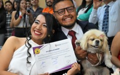 Diana Tupiza and Andres Alquinga pose with their dog Luna, who served as a "witness" at their civil wedding and stamped the marriage certificate with her paw print