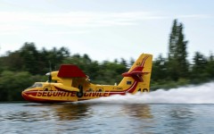 A firefighting plane scooped up water from the Seine river to douse the fire in Fontainebleau forest southeast of Paris