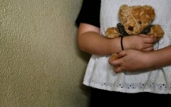 Bobo a woman who suffered persistent child sexual abuse for several years, holds a teddy bear