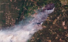 This handout satellite photograph taken on July 24, 2026 and released by 2026 Planet Labs PBC shows smoke rising from the wildfire in Le Porge and Lege-Cap-Ferret in France