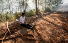 A volunteer rests amid operations to tackle a wildfire in Fethiye, southwest Turkey