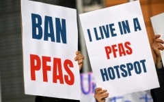 Environmental activists hold placards during a demonstration against PFAS chemicals next to the EU Commission headquarters in Brussels in March 2026