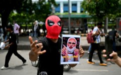 A Cockroach Janta Party supporter holds a doctored picture of India's Prime Minister Narendra Modi at a rally in New Delhi on July 25. Modi said he wanted to "forgive" protesters who abused him