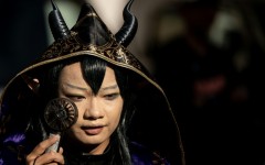 A cosplayer uses a portable fan to cool down while visiting the Osu Shopping Street before the Osu Cosplay Parade, during the second day of the World Cosplay Summit 2026 in Nagoya on August 1, 2026.