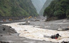 Excavators work in Tibet after disastrous flooding and landslides that struck the border with Nepal
