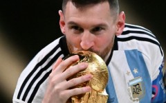 Lionel Messi kisses the World Cup trophy after winning the 2022 final against France in Doha