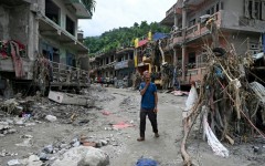 A man walks past damaged houses following flash floods at Devighat in Nepal's Nuwakot district on August 31, 2026