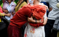 People mourn their missing relatives in the aftermath of flash floods, outside a mortuary in Nepal's Chitwan district