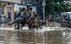 A horse cart transports passengers through a flooded street in Dakar, on October 5, 2026