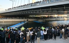 Visitors watch Wednesday's bid to guide a 3.5-metre shark back to the sea after it became trapped in an artificial waterway in the southeastern port city of Busan