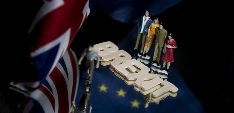  In this file photo taken on January 03, 2020 This picture taken in Brussels on January 5, 2020 shows the flags of the United Kingdom and the European Union and figurines next to the "Brexit" word .