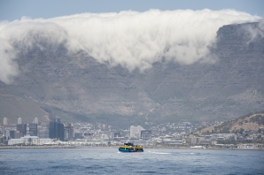 File: A ferry, with Table Mountain and part of the city in view, takes visitors back to the mainland after a tour of Robben Island.