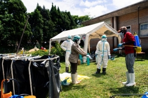 Zimbabwe health workers sprayed with disinfectant ahead of a vaccination programme which saw vice president and Minister of Health Constantino Chiwenga receive the first shot of Sinopharm in the southern African country which received a donation of 200 000 doses of the COVID-19 vaccine from China, February 18 2021.