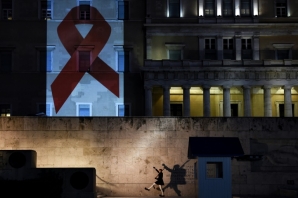 The Greek parliament is illuminated with the Red Ribbon logo of HIV AIDs during the World AIDS Day on December 1, 2016