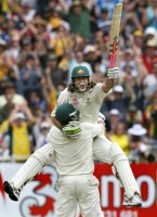 Andrew Symonds leaps into the arms of Matthew Hayden after scoring his maiden Test century against England at Melbourne in 2006