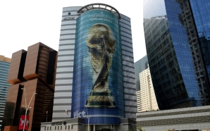 An image of the World Cup trophy adorns a building in Doha