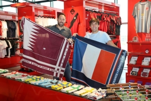 Bertrand Roine and Didier Grande are pictured with fan scarves they designed in the national colours of teams playing in the football World Cup