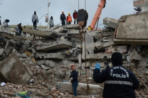 Rescuers take periodic pauses and listen for signs of life from those buried under the rubble