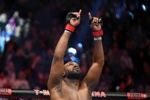 Jon Jones celebrates after routing France's Ciryl Gane to win the vacant UFC heavyweight crown
