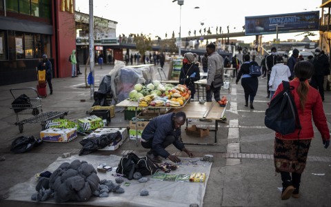 File: An informal vendor sets up his stall. AFP/Michele Spatari