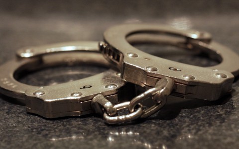 File: A pair of handcuffs on a table. Getty Images/James C Hooper
