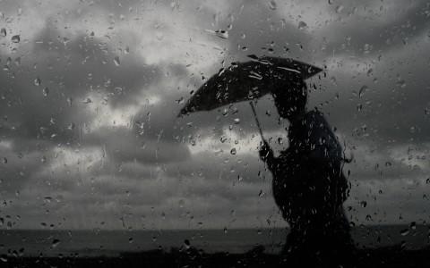 File: A man with an umbrella walking in the rain. Thilina Kaluthotage/NurPhoto via AFP