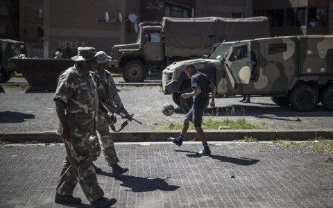  soldiers patrol a residential complex in Westbury, Johannesburg. AFP/Marco Longari