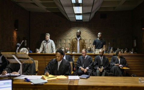 Kemi Seba (centre) was arrested alongside his son and a South African national