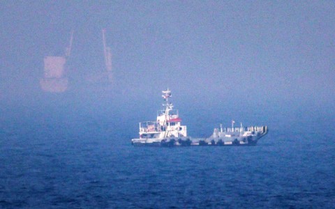 Ships sail near the Strait of Hormuz off the eastern coast of the United Arab Emirates at Khor Fakkan on July 13, 2026